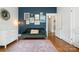 Stylish bedroom with a striking navy accent wall and eclectic decor at 255 South Academy St, Mooresville, NC 28115