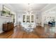 Elegant dining room with hardwood floors, modern chandelier, and access to other rooms at 255 South Academy St, Mooresville, NC 28115