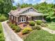 Aerial view of a brick home with a lush lawn, mature landscaping, and a long driveway at 255 South Academy St, Mooresville, NC 28115