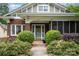 Charming brick home showcasing a beautifully landscaped front yard with an inviting front door at 255 South Academy St, Mooresville, NC 28115
