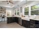 Bright kitchen with stainless steel appliances, apron sink and black cabinets with gold hardware at 255 South Academy St, Mooresville, NC 28115