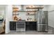 Updated kitchen featuring stainless steel appliances, floating shelves and black cabinets with gold hardware at 255 South Academy St, Mooresville, NC 28115