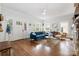 Bright living room featuring hardwood floors, a fireplace, and a comfortable blue sectional sofa at 255 South Academy St, Mooresville, NC 28115