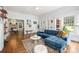 Bright living room featuring hardwood floors, a fireplace, and a comfortable blue sectional sofa at 255 South Academy St, Mooresville, NC 28115