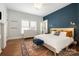 Cozy bedroom features accent wall, rug, and lots of natural light at 255 South Academy St, Mooresville, NC 28115