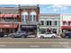 Street view featuring storefronts with vintage architectural details and parked cars at 255 South Academy St, Mooresville, NC 28115