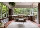 Relaxing sunroom with brick columns, cozy seating, and natural light at 255 South Academy St, Mooresville, NC 28115