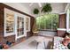 Cozy screened in porch with plants, brick columns, and furniture at 255 South Academy St, Mooresville, NC 28115