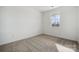 Bright bedroom with a neutral color palette, carpet, and window overlooking the landscape at 2592 Blue Sky Meadows Dr, Monroe, NC 28110