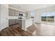 Modern kitchen with gray cabinets, white countertops, stainless steel microwave, and wood-look flooring at 2592 Blue Sky Meadows Dr, Monroe, NC 28110