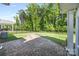 Backyard featuring a stone fire pit, dark metal fence, and lush green lawn and trees at 2658 Manor Stone Way, Indian Trail, NC 28079