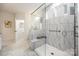 Bathroom featuring seamless glass shower with marble tile, bench, and modern fixtures at 2658 Manor Stone Way, Indian Trail, NC 28079