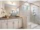 Modern bathroom with glass shower, granite countertop, and double vanity sinks at 2658 Manor Stone Way, Indian Trail, NC 28079