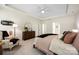 Bedroom with bright light and furnishings includes ceiling fan and a view to the en suite at 2658 Manor Stone Way, Indian Trail, NC 28079