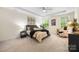 Bright bedroom boasts natural light, neutral tones, stylish furnishings, and ceiling fan at 2658 Manor Stone Way, Indian Trail, NC 28079
