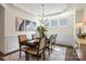 An open dining room featuring a dark wood table, seating for six, and abundant light at 2658 Manor Stone Way, Indian Trail, NC 28079