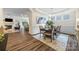 An open floor plan of the living spaces showcasing a dining room with hard wood floors at 2658 Manor Stone Way, Indian Trail, NC 28079