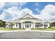 Elegant white clubhouse with symmetrical design, landscaping, and arched entryways at 2658 Manor Stone Way, Indian Trail, NC 28079