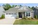 Charming home featuring a gray roof, stone accents, manicured lawn and an attached two car garage at 2658 Manor Stone Way, Indian Trail, NC 28079