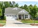 Charming single-Gathering home with a two-car garage, covered porch, and manicured lawn at 2658 Manor Stone Way, Indian Trail, NC 28079