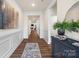 Long hallway with decorative wainscoting and hard wood floors at 2658 Manor Stone Way, Indian Trail, NC 28079