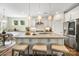Bright kitchen with large island, modern lighting, stainless appliances, and breakfast area at 2658 Manor Stone Way, Indian Trail, NC 28079