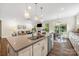 Open-concept kitchen and living room layout, with an easy transition to the dining area at 2658 Manor Stone Way, Indian Trail, NC 28079
