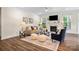 Cozy living room with fireplace, ceiling fan, and lots of natural light at 2658 Manor Stone Way, Indian Trail, NC 28079