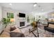 Comfortable living room with fireplace next to a view of kitchen and dining area at 2658 Manor Stone Way, Indian Trail, NC 28079