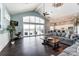 Open lounge area with a vaulted ceiling, hardwood floors, kitchen, and access to a patio at 2658 Manor Stone Way, Indian Trail, NC 28079