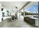 Outdoor kitchen and bar area with built-in grill and seating overlooking pool at 2658 Manor Stone Way, Indian Trail, NC 28079