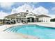 Community pool with sun loungers and view of the clubhouse at 2658 Manor Stone Way, Indian Trail, NC 28079