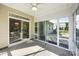 Bright sunroom featuring an overhead fan, many windows, and access to the backyard at 2658 Manor Stone Way, Indian Trail, NC 28079