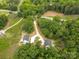 Aerial view of the homes showing a long driveway surrounded by trees at 27 Mickley Ave, Bessemer City, NC 28016