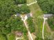 Aerial view of a property with lush greenery, long driveways, and multiple buildings at 27 Mickley Ave, Bessemer City, NC 28016