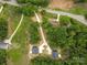 Aerial view showing homes surrounded by wooded areas, long driveways, and natural beauty at 27 Mickley Ave, Bessemer City, NC 28016