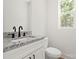 Bathroom featuring granite countertops, white cabinets, and a modern faucet at 27 Mickley Ave, Bessemer City, NC 28016