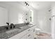 Bathroom featuring double vanity, granite countertops, and tiled shower at 27 Mickley Ave, Bessemer City, NC 28016