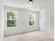 Bright bedroom with plush carpet, two large windows providing natural light, and fresh white walls at 27 Mickley Ave, Bessemer City, NC 28016
