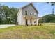 Inviting two-story home with a covered front porch, gray accents, well-maintained landscaping, and a driveway on the side at 27 Mickley Ave, Bessemer City, NC 28016