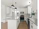 Modern kitchen with granite countertops, stainless steel appliances, white cabinetry, and stylish pendant lighting at 27 Mickley Ave, Bessemer City, NC 28016