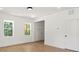 Bright living room with light hardwood floors, white walls, recessed lighting, and large windows offering scenic views at 27 Mickley Ave, Bessemer City, NC 28016