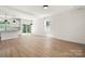 Expansive living space showcasing hardwood floors, bright white walls, recessed lighting, and views of the backyard at 27 Mickley Ave, Bessemer City, NC 28016