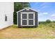 Storage shed with gray siding, white trim, and a double door entry at 27 Mickley Ave, Bessemer City, NC 28016