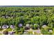 Aerial view of a neighborhood surrounded by lush greenery and mature trees at 2725 Cotton Planter Ln, Charlotte, NC 28270