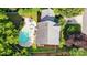 Backyard aerial view featuring a beautiful pool, deck with lounge chairs, and manicured landscaping at 2725 Cotton Planter Ln, Charlotte, NC 28270