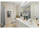 This bathroom features a dual vanity with a decorative mirror and upgraded plumbing fixtures at 2725 Cotton Planter Ln, Charlotte, NC 28270