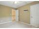Bedroom with neutral walls, carpet flooring, and access to additional room at 2725 Cotton Planter Ln, Charlotte, NC 28270