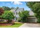 Charming two-story home featuring gray siding, black shutters, mature trees, and an attached two-car garage at 2725 Cotton Planter Ln, Charlotte, NC 28270