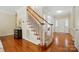 Lovely foyer features hardwood floors, staircase with white spindles, and direct access to the main entry at 2725 Cotton Planter Ln, Charlotte, NC 28270